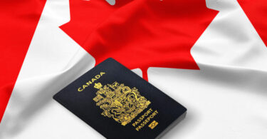 passport of Canada on the top of an satin canadian flag